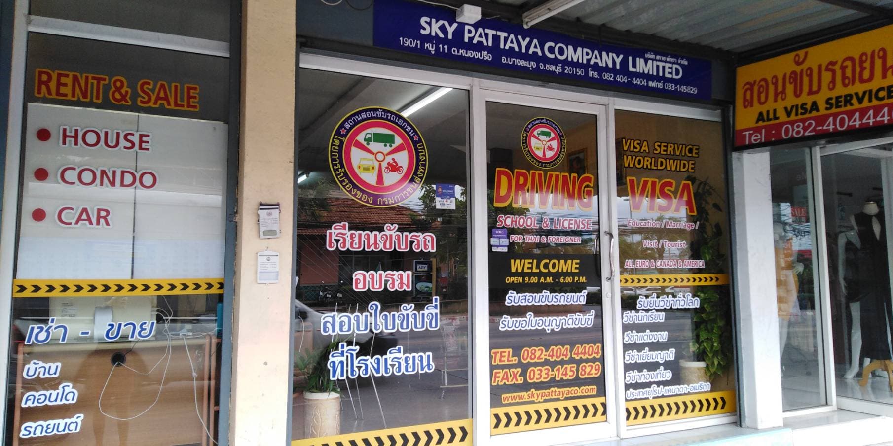The Sky Pattaya office on Thepprasit Road, with signs for driving school, visa services and house, condo and car rental